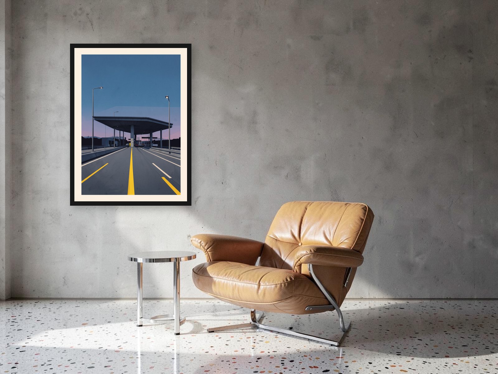 Autostrada framed in black on a concrete wall above a tan leather chair
